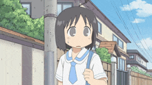 a girl in a white shirt and blue tie stands in front of a building
