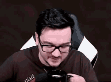 a man wearing glasses is drinking from a cup that says happy hour .
