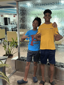 two boys posing for a picture with one wearing a t-shirt that says england