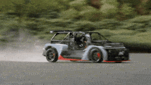 a car with the letter n on the side is driving down a road