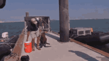 a man and a dog on a boat with a red cooler that says ' cooler ' on it