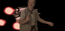 a man is dancing in front of a space ship with red lights
