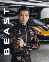 a man wearing a black and gold jacket with the word beast written on it
