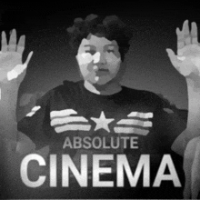 an ad for absolute cinema shows a man with his hands in the air