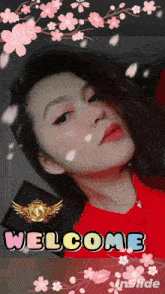 a woman in a red shirt is surrounded by pink flowers and the word welcome
