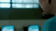 a blurry photo of a person looking at a computer screen
