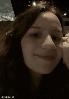 a woman is making a funny face with her hand to her face