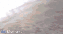 a blurry picture of a person with the word momento in the upper right corner