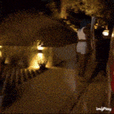 a person standing next to an ambulance that says emergency