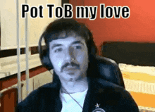 a man wearing headphones is sitting in a chair and says pot tob my love