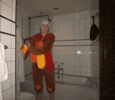a man in a turkey costume stands in a bathroom next to a bathtub