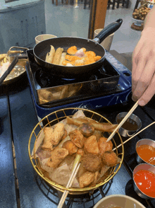 a person is cooking food on a portable stove that says lex