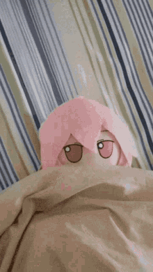 a person is putting their hand on a stuffed animal that is laying on a bed .