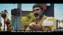 a man with a beard is holding a cup of coffee and asking when you not going to be fucking idiot boy