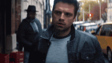 a man in a hat is walking down the street