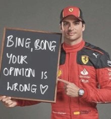 a man in a ferrari suit holds a sign that says bing bong your opinion is wrong
