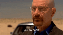 a bald man with glasses and a beard is saying say my name