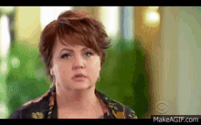 a close up of a woman 's face with the website makeagif.com in the corner