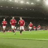 a group of soccer players are running on a field with a sign in the background that says ' aerostar '