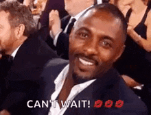 a man in a suit and tie is smiling in a crowd of people .