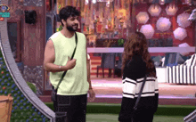 a man and a woman are standing next to each other in a room with a sign that says big boss on it
