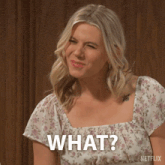 a woman in a floral top is asking what