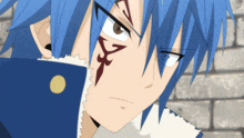 a close up of a person with blue hair and a tattoo on their face
