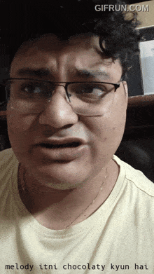 a man wearing glasses and a yellow shirt says melody itni chocolatey kyun hai on the bottom