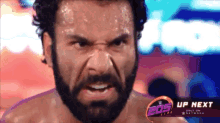 a man with a beard is sweating in front of a sign that says eos up next