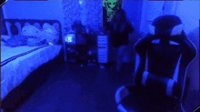 a person is standing in a room with a chair and a bed
