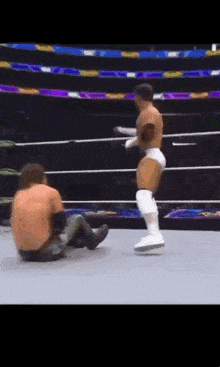 a wrestler kicking another wrestler in the face