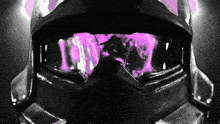 a close up of a helmet with purple flames coming out of the eyes