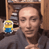 a woman with a sticker of a minion in front of a bookshelf that says shared service
