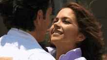 a man and a woman are hugging and smiling
