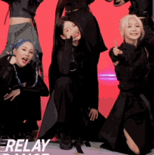 a group of girls are posing for a picture and the word relay is on the bottom right