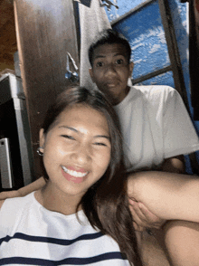 a man and a woman are posing for a photo and the woman is smiling