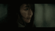a close up of a woman 's face with a tear running down her cheek