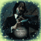 a picture of a man holding a gun with jonathan loves toby written in the corner