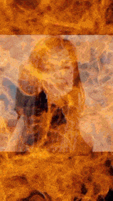 a woman 's face is surrounded by flames and smoke .