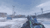 a person holding a gun in a snowy area with a fence in the background