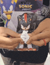 a person is holding a sonic prime toy
