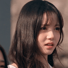 a close up of a woman 's face with long hair