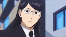 a man with long black hair wearing glasses and a tie