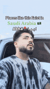 a man with a beard is sitting in a car with the words places like this exist in saudi arabia abha