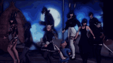 a group of people are posing for a picture with a moon in the background