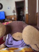 a couple of stuffed animals are laying on a couch