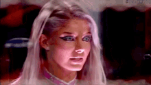 a woman with white hair and blue eyes is wearing a pink choker and earrings .