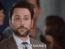 a man in a suit and tie is giving a thumbs up .