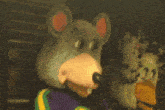 a stuffed animal in a chuck e cheese costume is looking at the camera