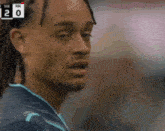 a close up of a man 's face with the number 20 on the bottom